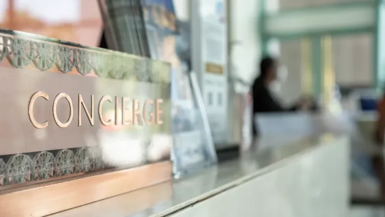 Photo of a concierge desk sign, representing premium client service and dedicated strategist access.